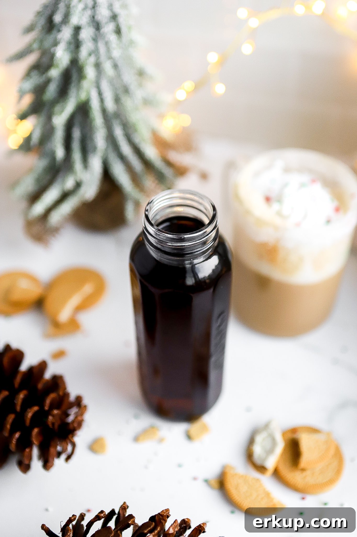 top down view of starbucks sugar cookie syrup in glass jar with christmas decorations on countertop