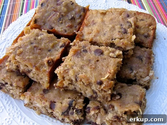 Banana Coconut Chocolate Chip Bars Recipe 3 Low Fat Banana Chocolate Chip Cookie Bars stacked on a white serving plate.