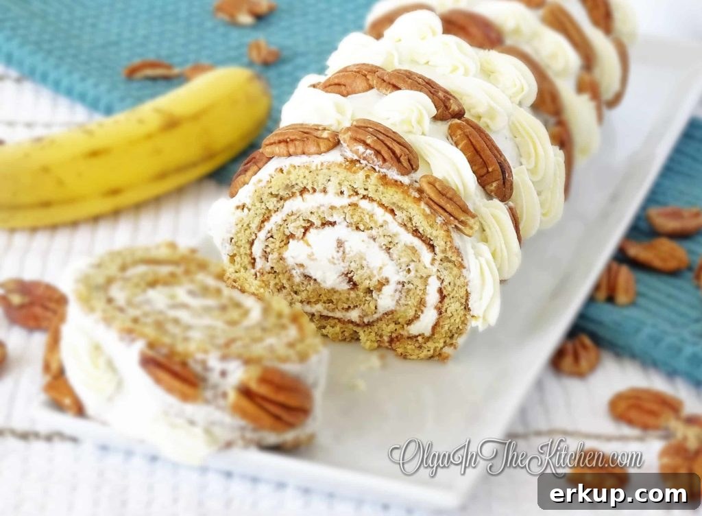 Banana Cake Roll Recipe with Cream Cheese Filling 3 Sliced banana cake roll on a board.