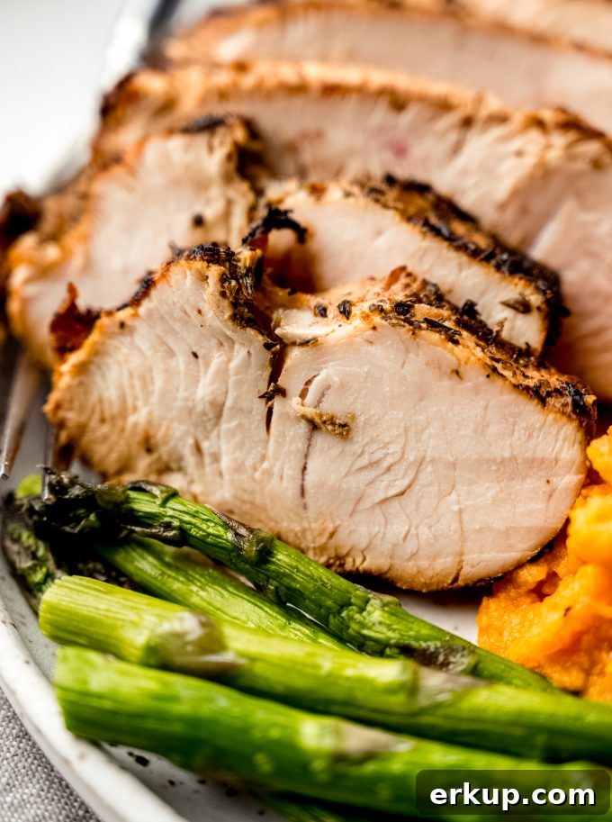 Juicy Oven-Roasted Turkey Tenderloin Recipe 13 A plate of turkey tenderloin, asparagus, and sweet potatoes.