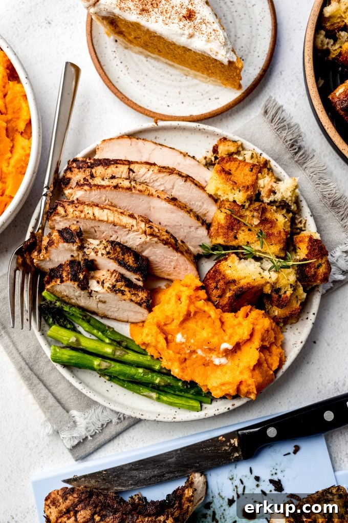 Juicy Oven-Roasted Turkey Tenderloin Recipe 14 Aerial photo of turkey tenderloin, asparagus, cornbread stuffing, and mashed sweet potatoes.
