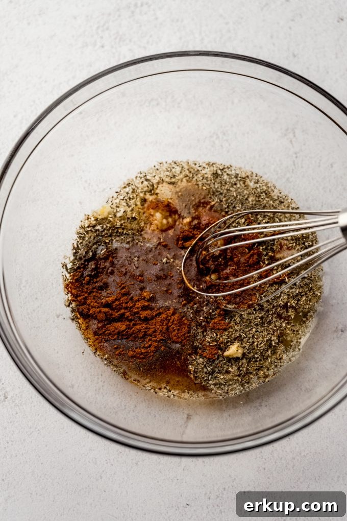 Juicy Oven-Roasted Turkey Tenderloin Recipe 5 The ingredients for turkey tenderloin marinade in a bowl with a whisk.