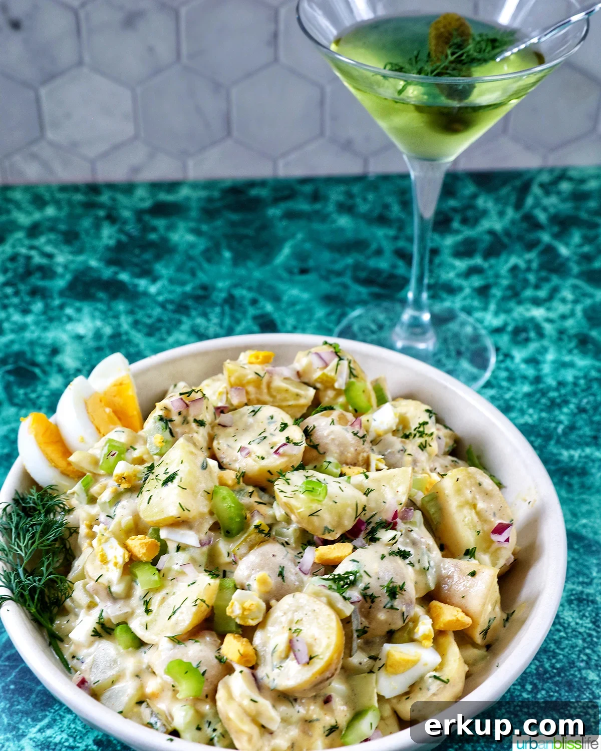 bowl of dill pickle potato salad and a dill pickle martini