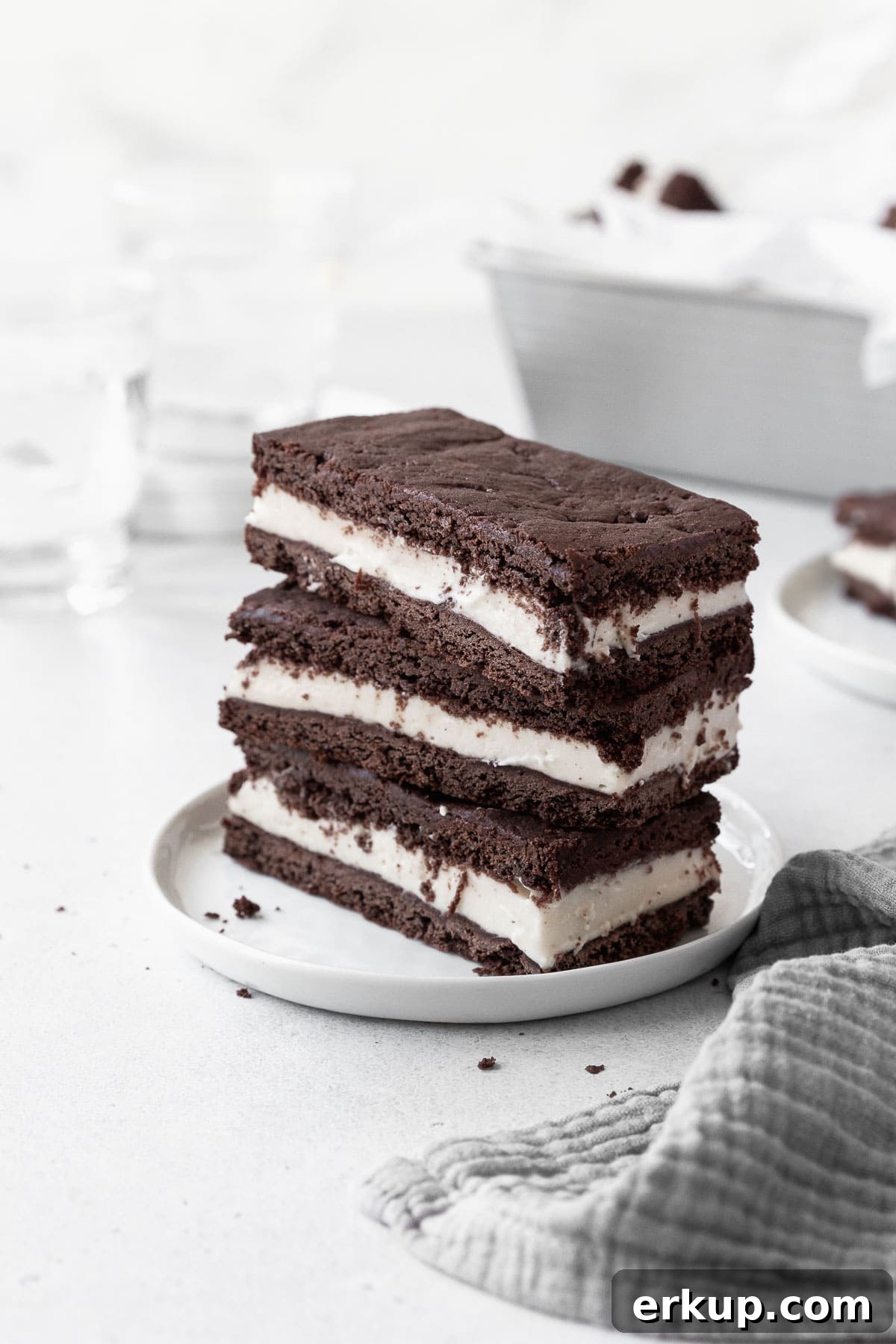 A stack of gluten-free ice cream sandwich cookies on a white dish.