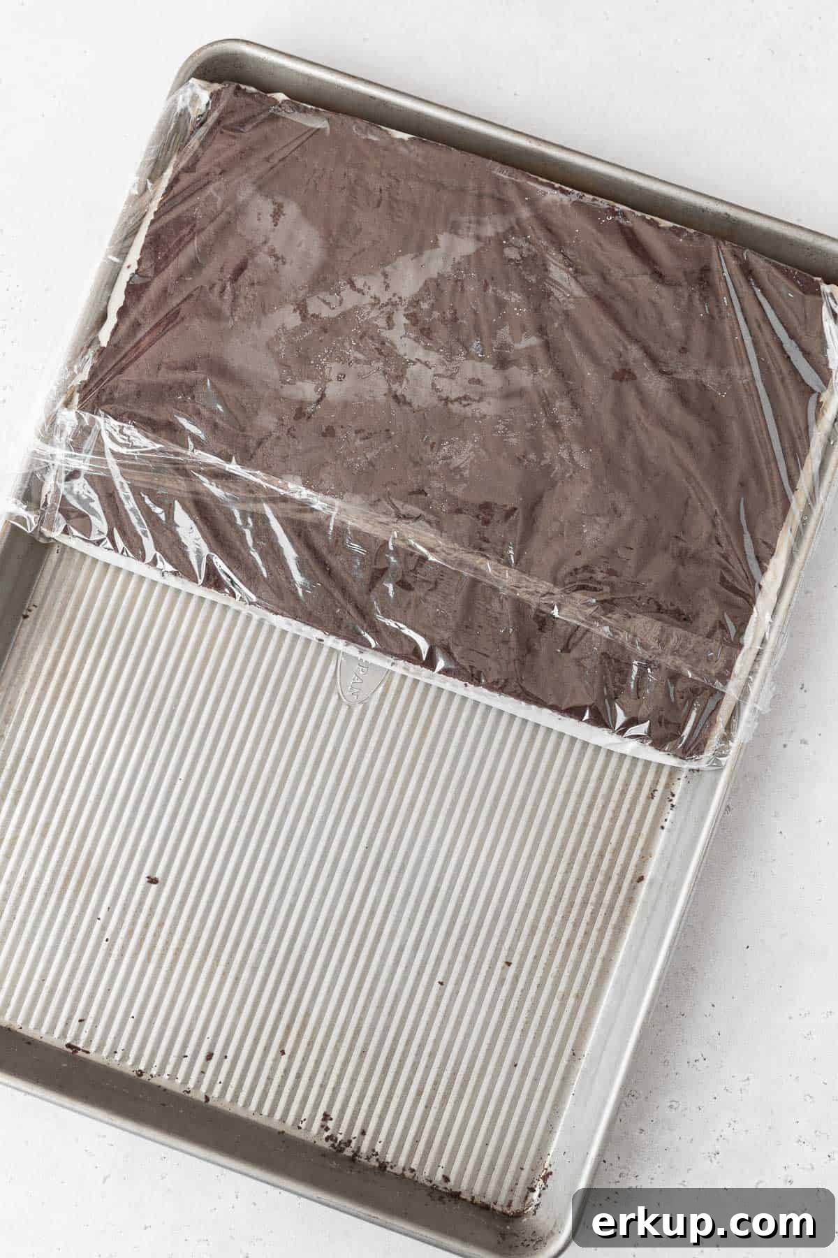 Stacking the gluten-free ice cream sandwich cookie together on a large cookie sheet.