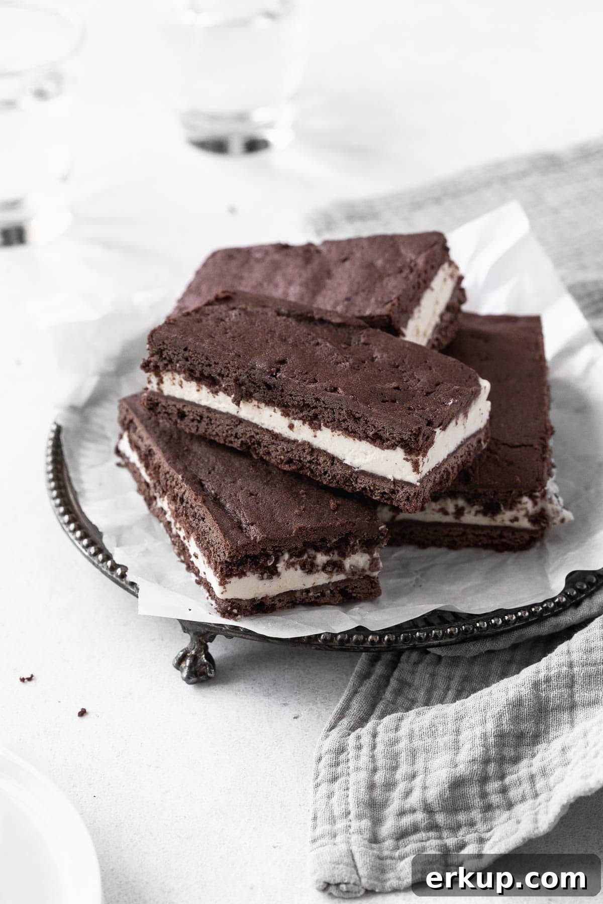A stack of gluten-free ice-cream sandwich cookies on an antique serving platter.