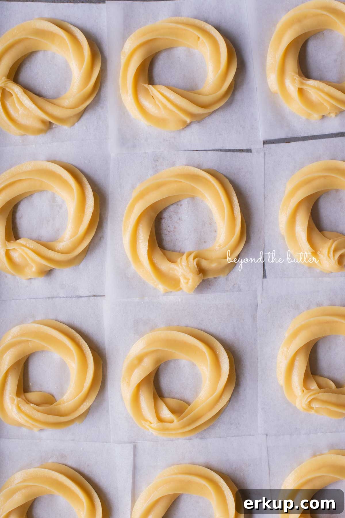 Piped choux pastry rings ready for frying