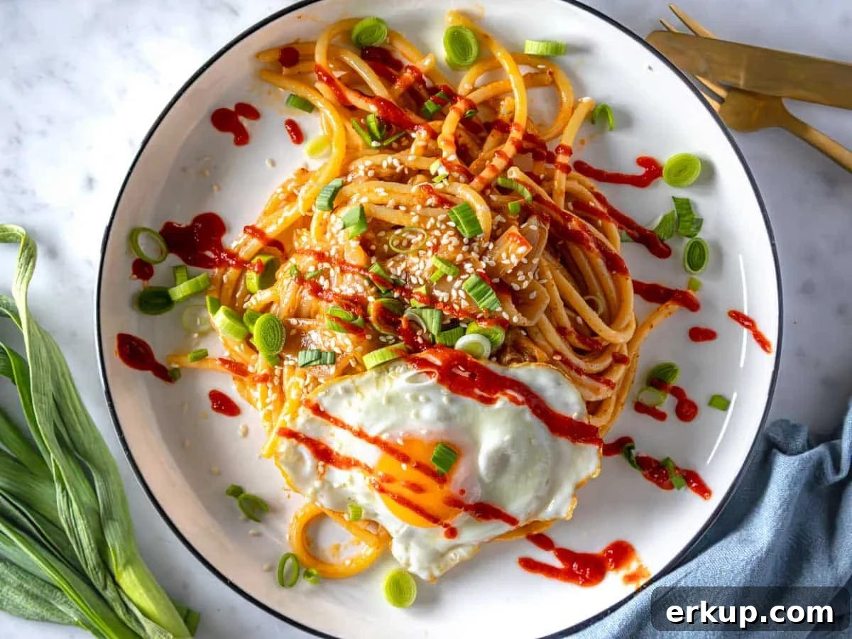 Miso pasta with sriracha sauce and a fried egg.