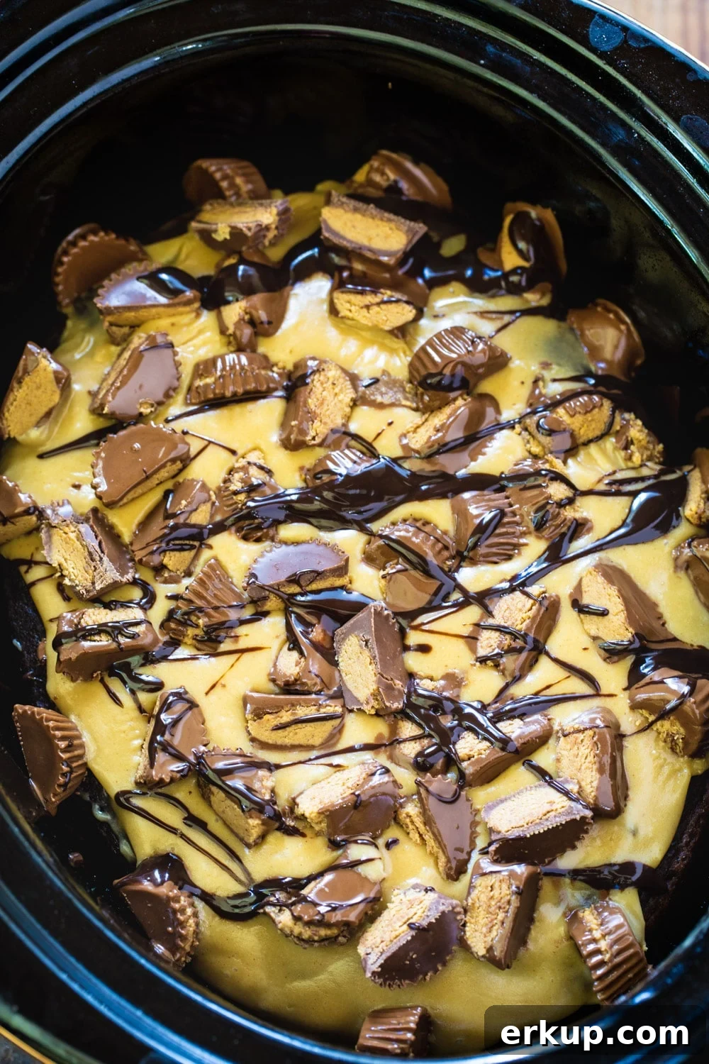 Slow Cooker Chocolate Peanut Butter Cake  topped with chopped peanut butter cups.