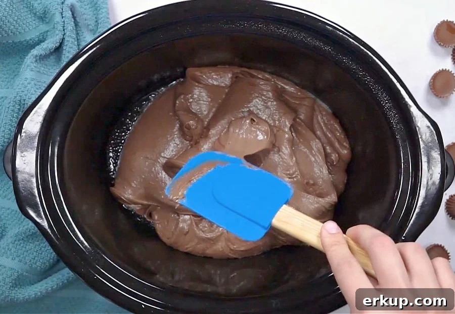 Batter being spread in slow cooker.