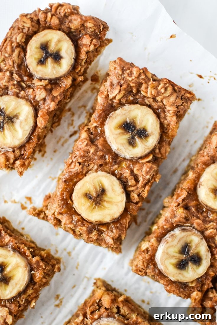 peanut butter banana oatmeal breakfast bars with sliced bananas on top.