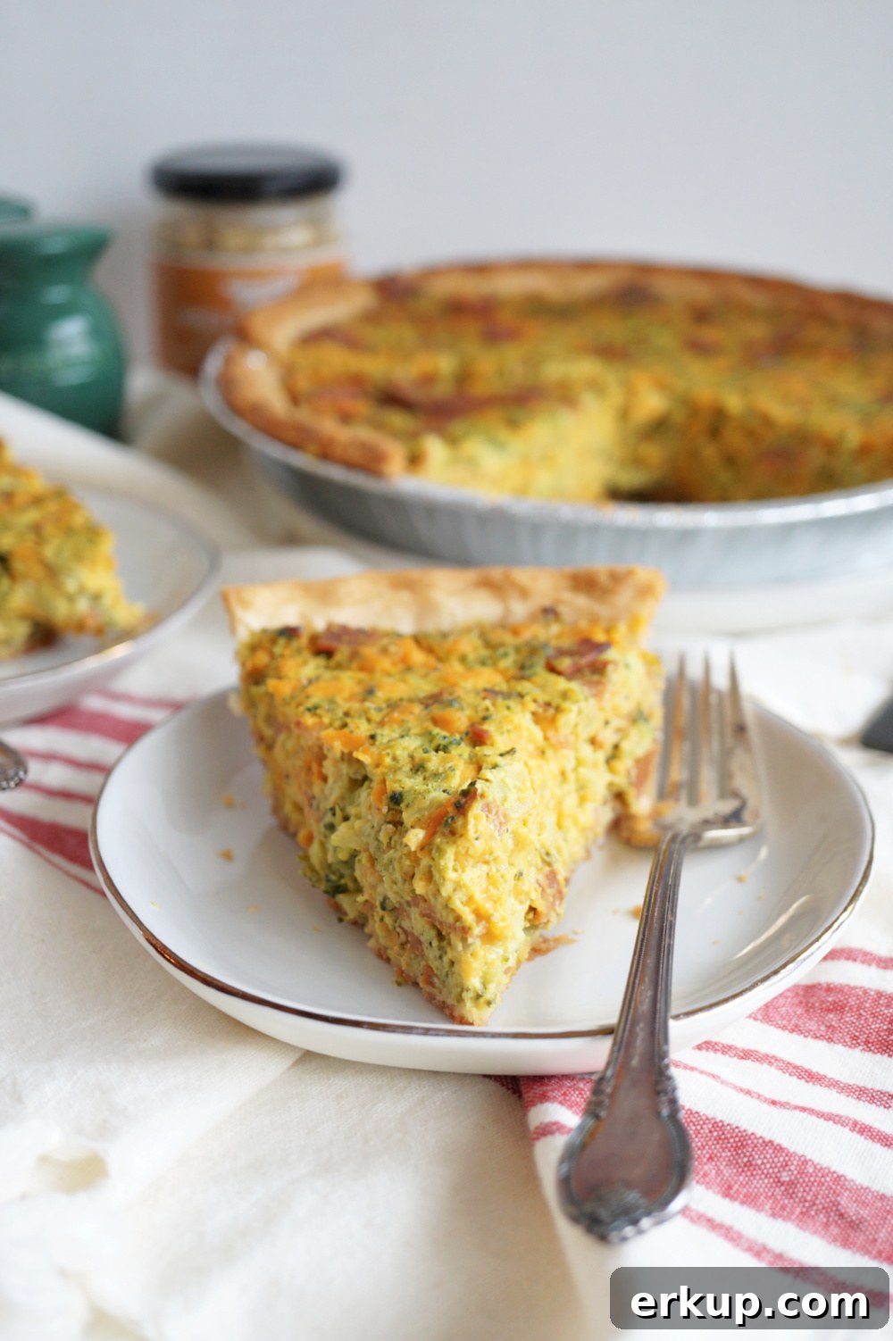 slice of broccoli cheese quiche on plate