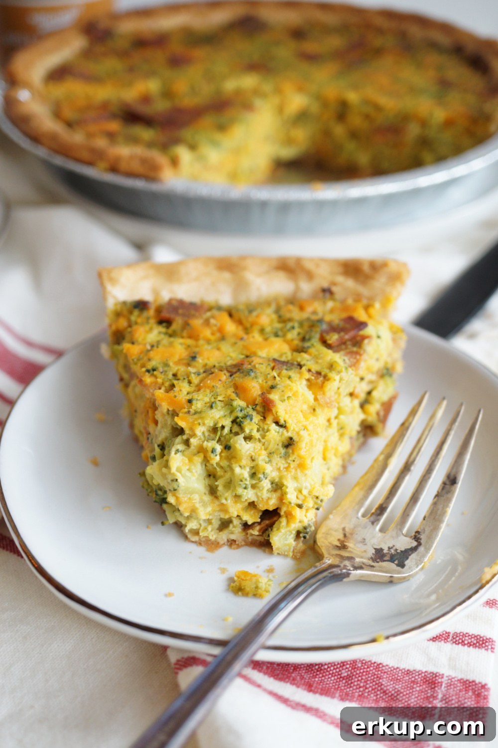 slice of quiche with bite missing