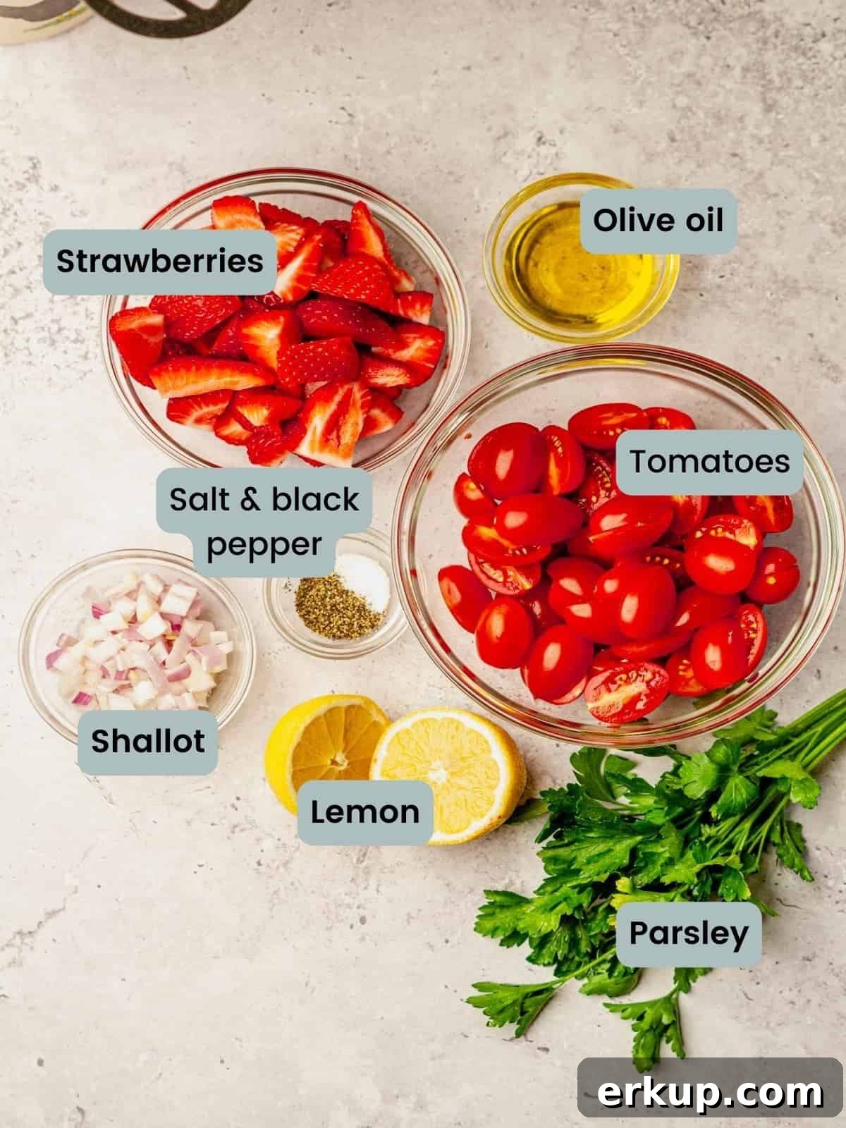 Ingredients measured out in glass bowls on gray surface.