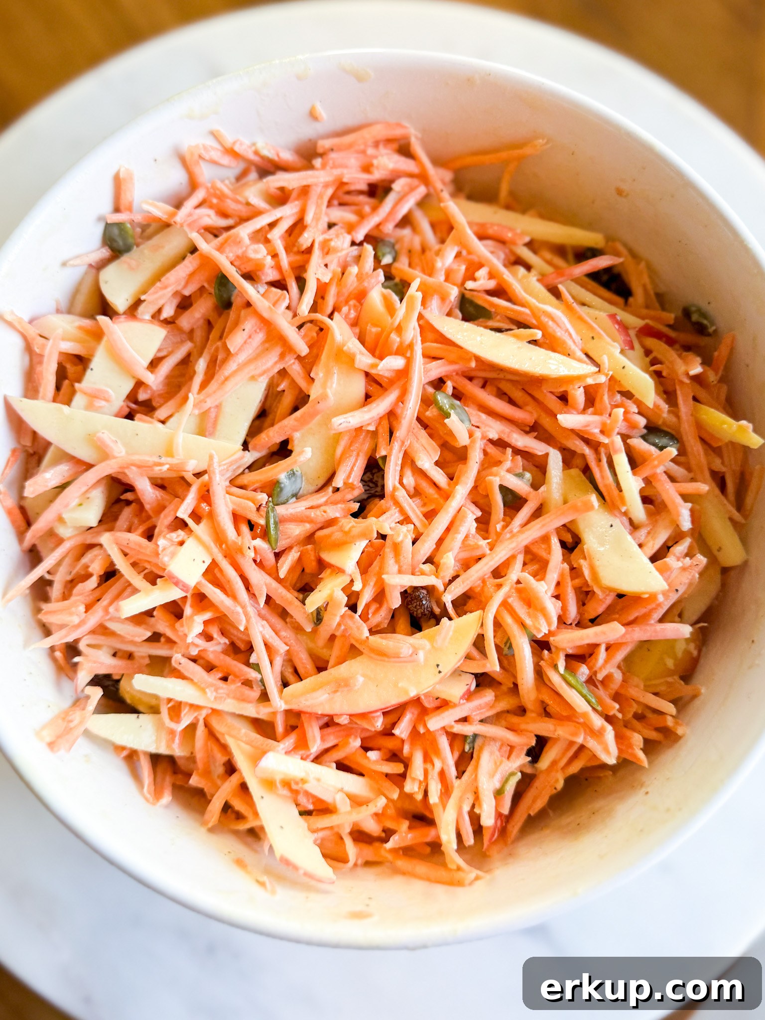 Close-up of shredded carrot salad with maple dijon dressing