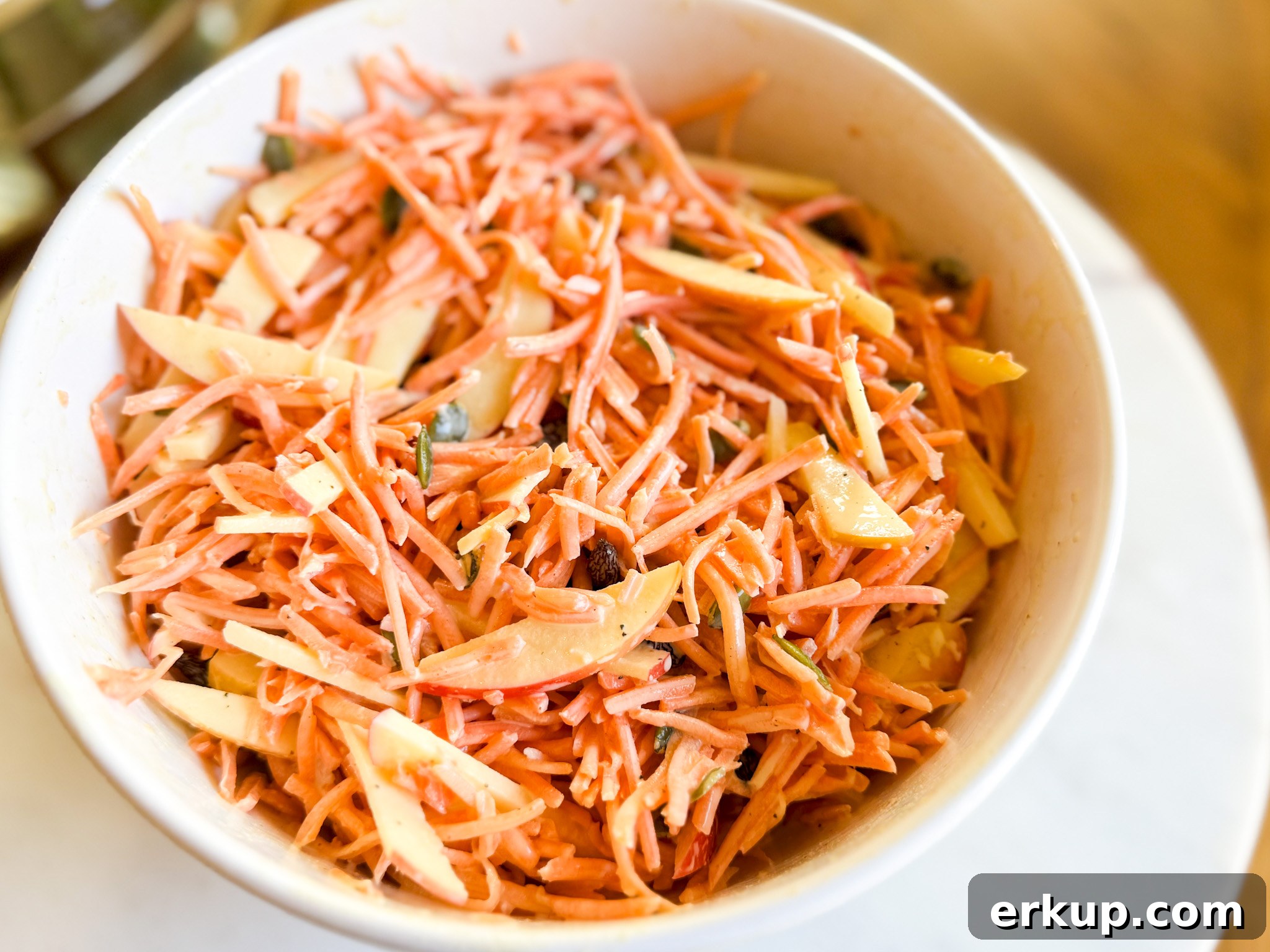 Bowl of maple dijon dressing next to ingredients
