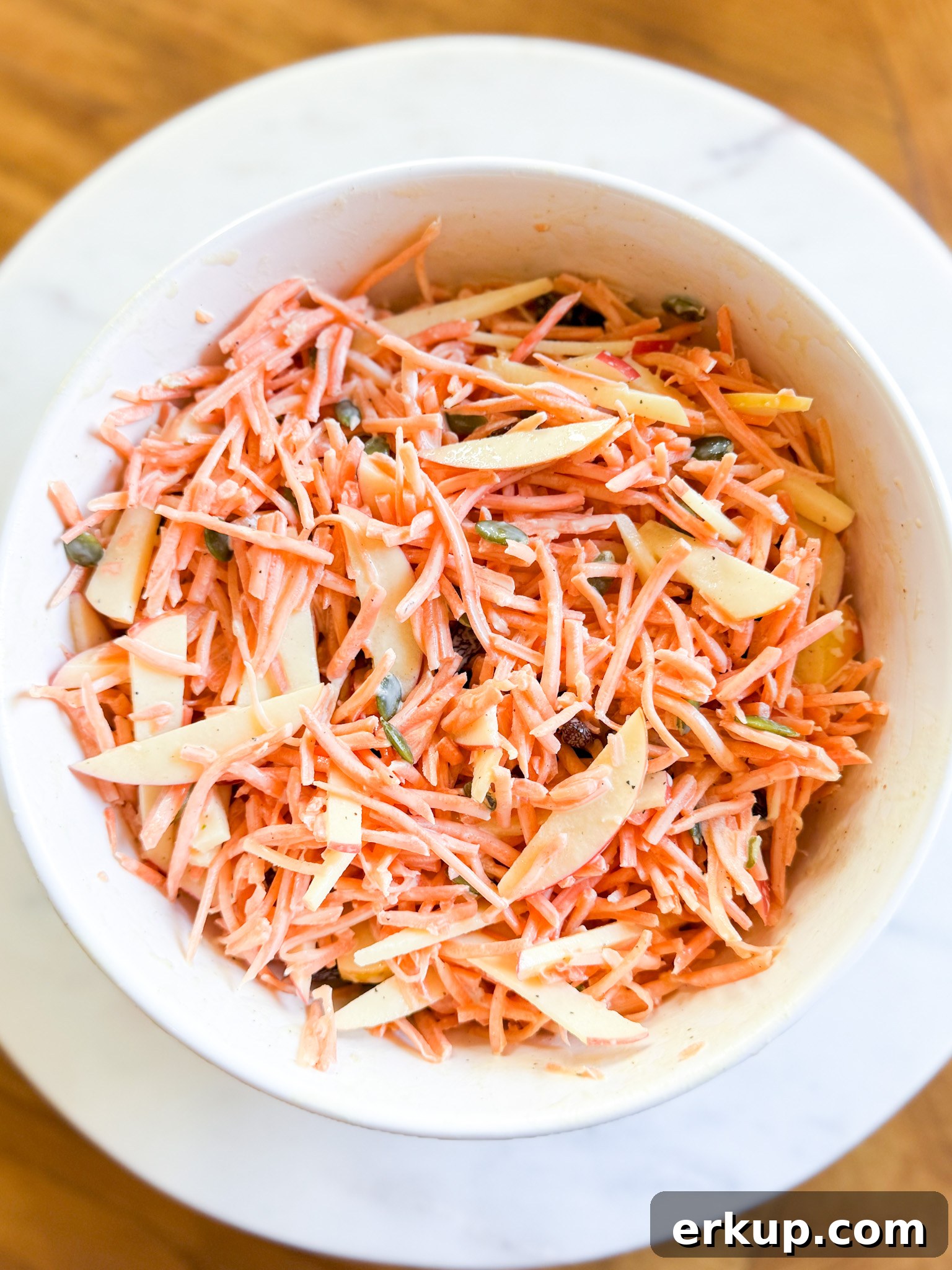 Serving suggestion for carrot slaw on a picnic table