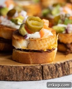 close up shot of mini sandwich on wooden board with more blurred in the background