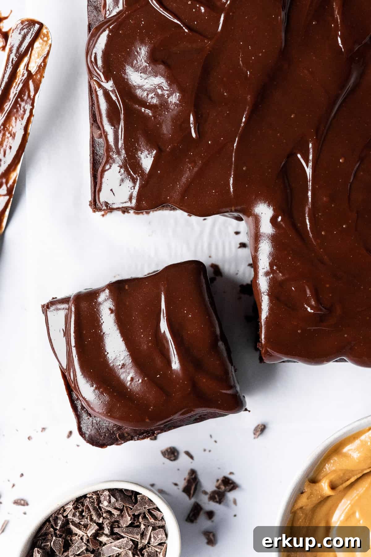 Close up of vegan chocolate banana cake with a piece sliced off.
