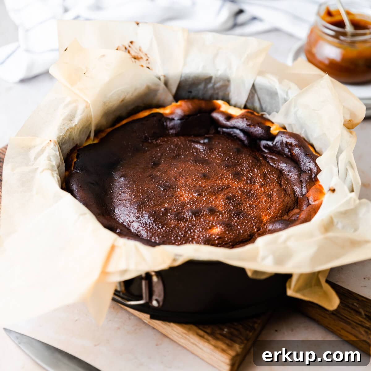 burnt cheesecake inside of the baking tin lined with plenty of baking paper.