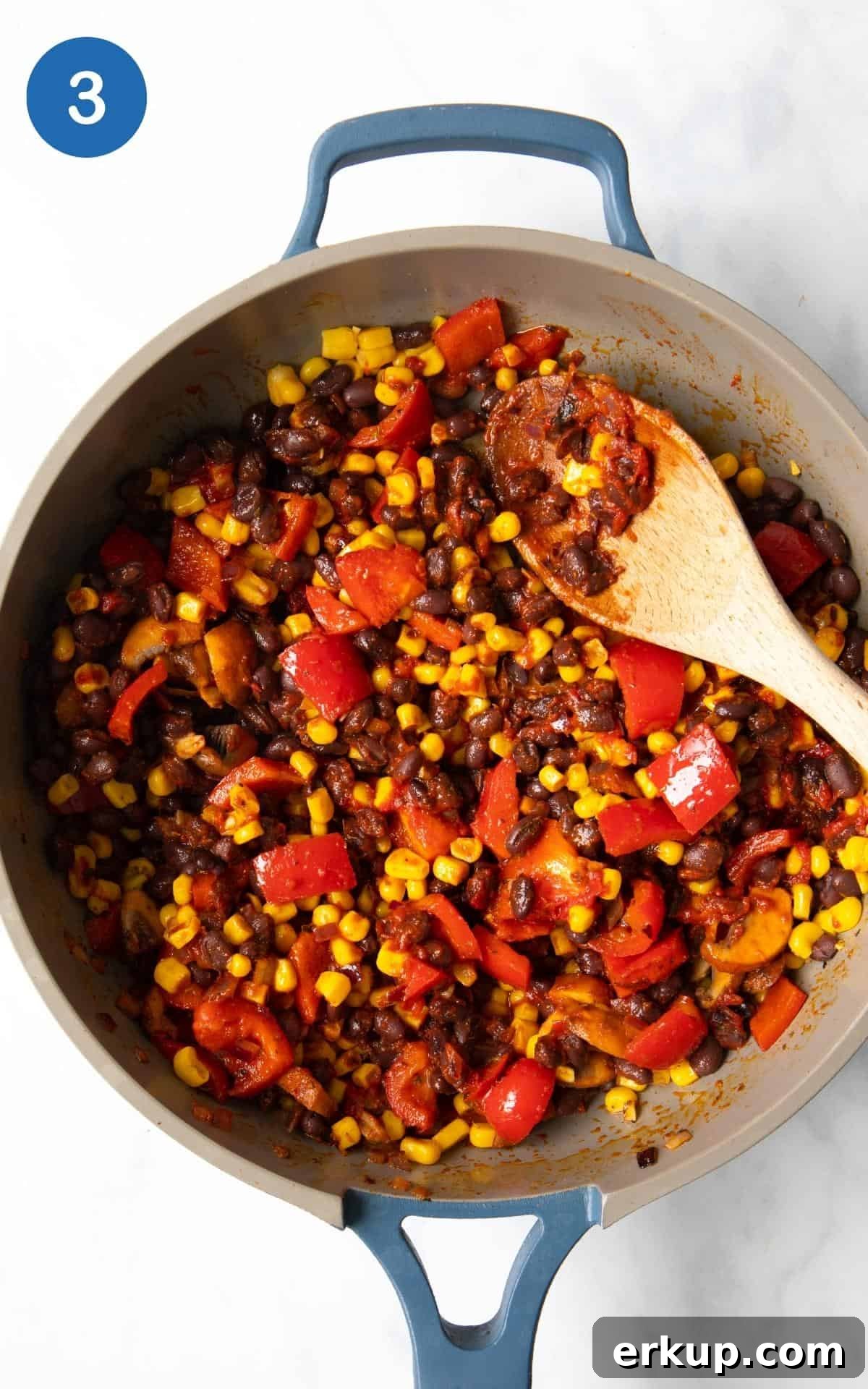 Black Bean Quesadillas Recipe with Creamy Avocado Salsa 6 Chopped Mushrooms, sweetcorn, Black Beans, Pepper, Mushrooms, spice, garlic, lime, onion, tomato puree, in a frying pan.