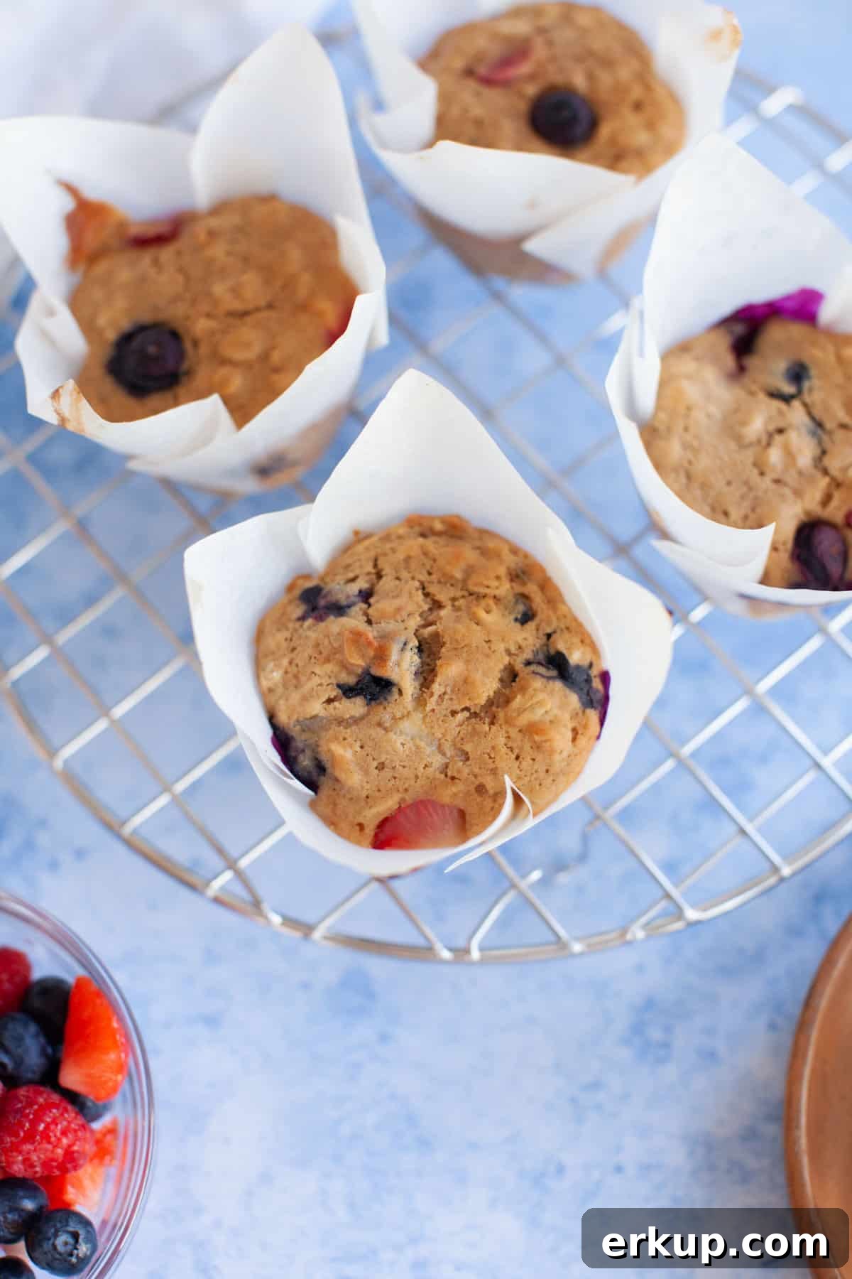 Mixed Berry Muffins Recipe: Moist Blueberry Raspberry Muffins 8 muffins on a cooling rack.