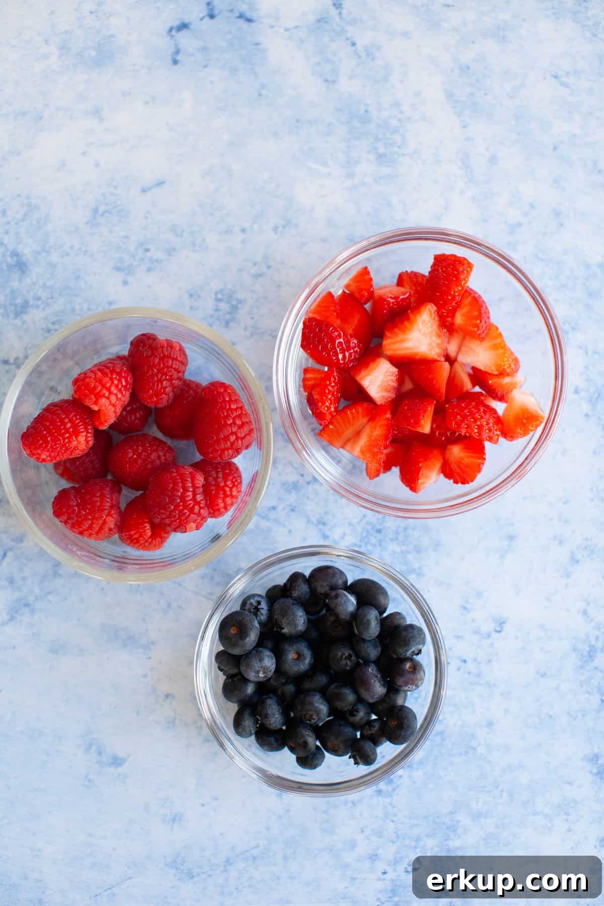 Mixed Berry Muffins Recipe: Moist Blueberry Raspberry Muffins 3 blueberries, raspberries and diced strawberries in bowls.
