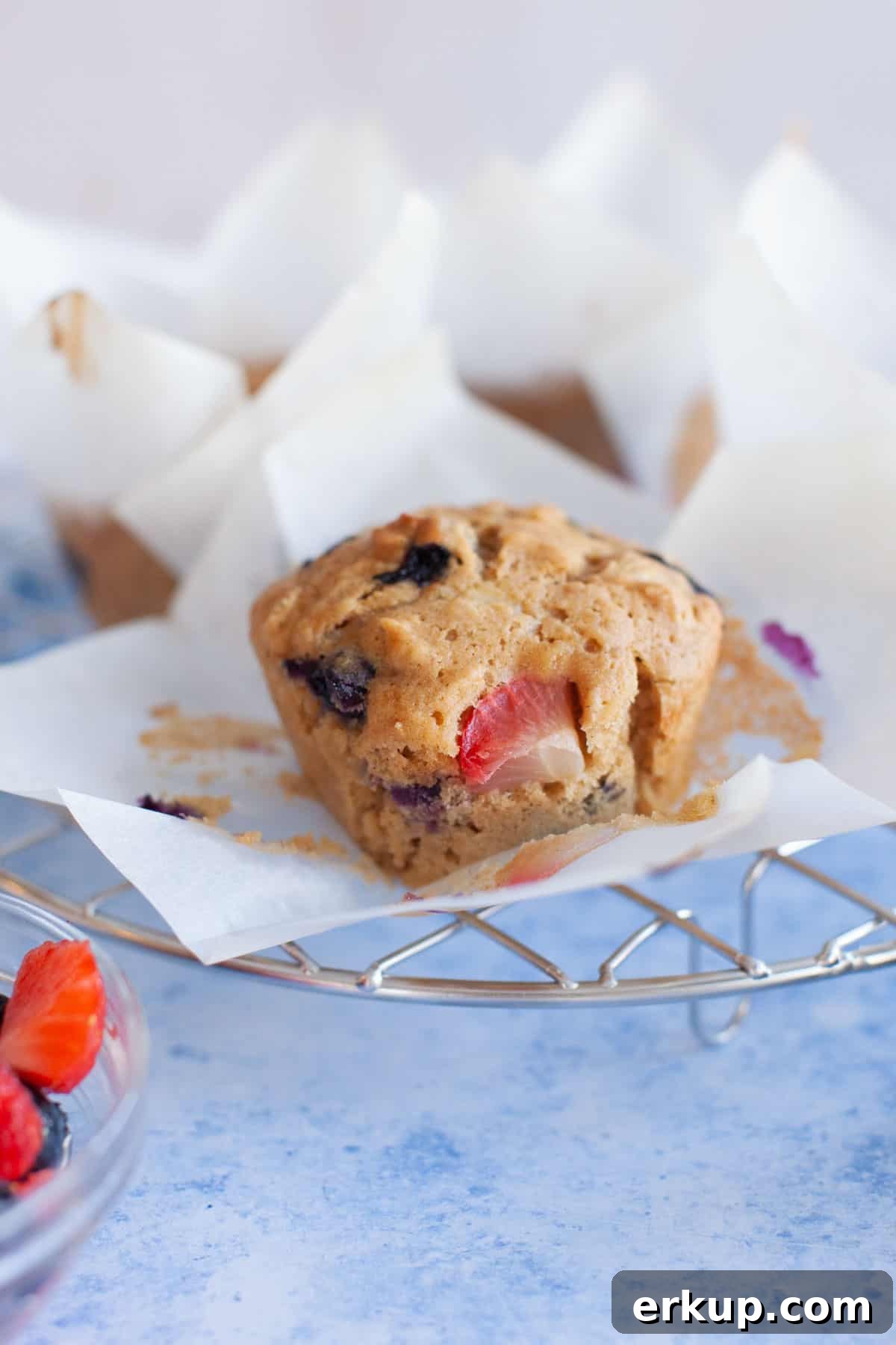 Mixed Berry Muffins Recipe: Moist Blueberry Raspberry Muffins 6 muffins with three kinds of berries on a cooling rack.