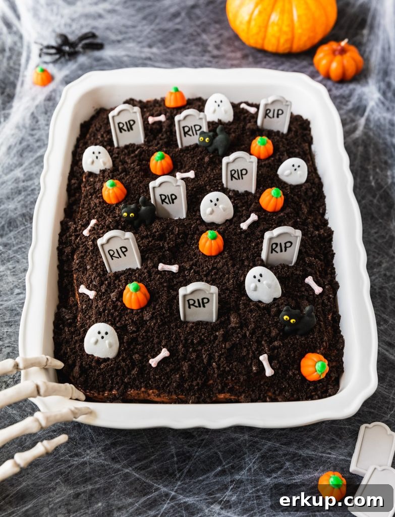 Chocolate cake decorated with Oreo cookie crumbs and Halloween candy