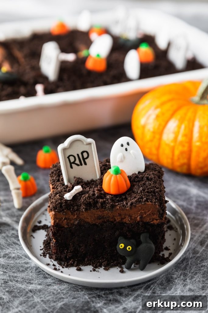 layered chocolate cake with tombstones and Halloween candy