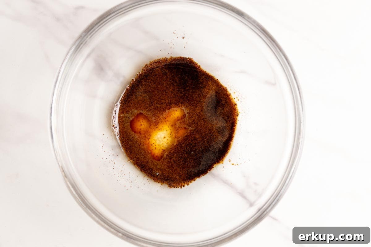 Instant espresso powder and water in a glass bowl.