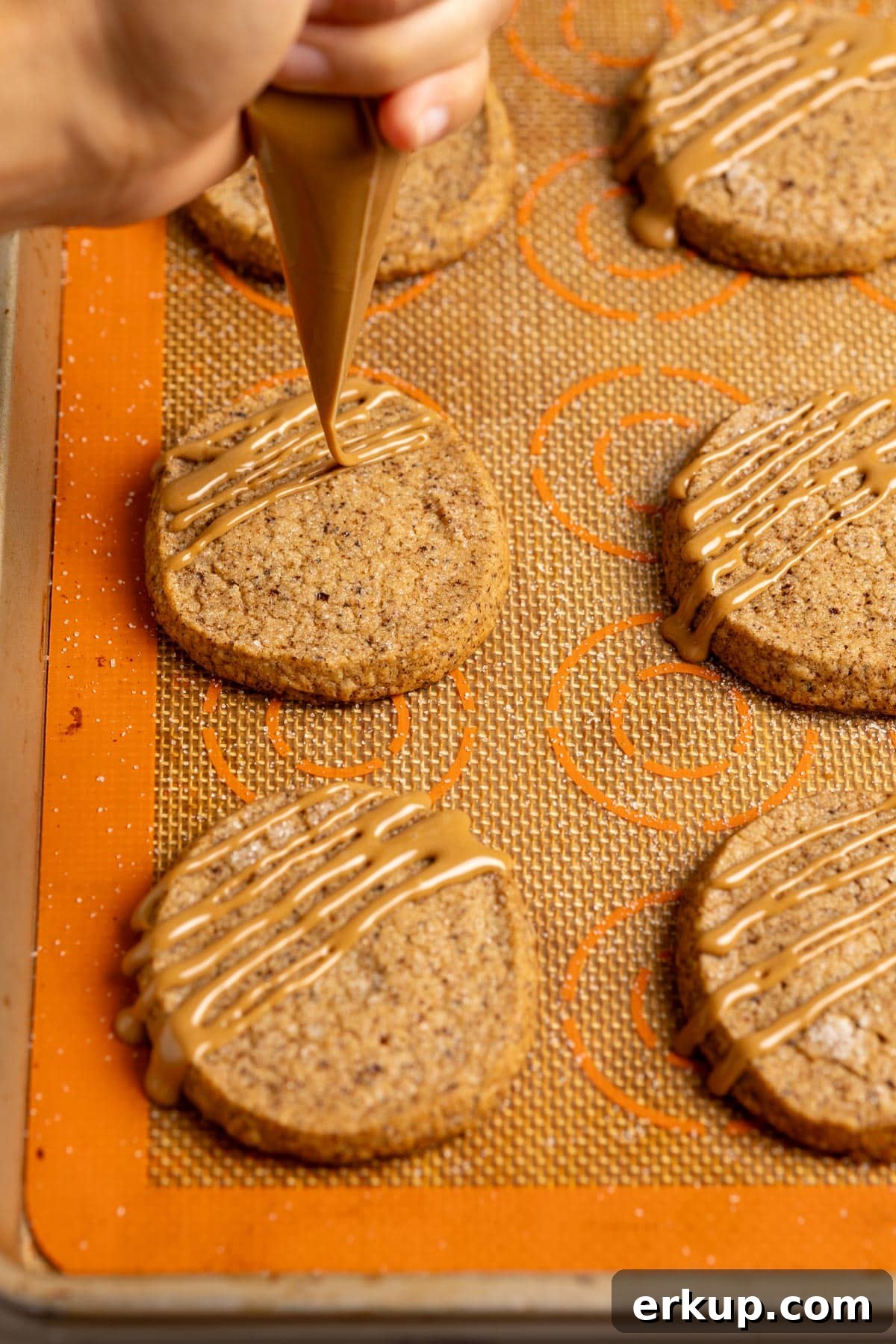 Drizzling glaze over coffee shortbread cookies.
