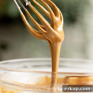 Vietnamese coffee glaze dripping down from a whisk.