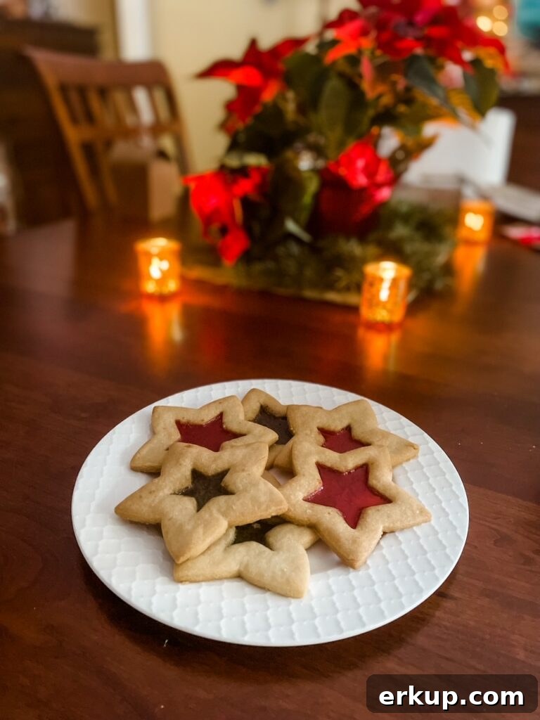 Stained Glass Cutout Sugar Cookies Recipe for Cookie Exchanges 2 A plate of the Stained Glass Cutout Sugar Cookies in front of a Christmas tree
