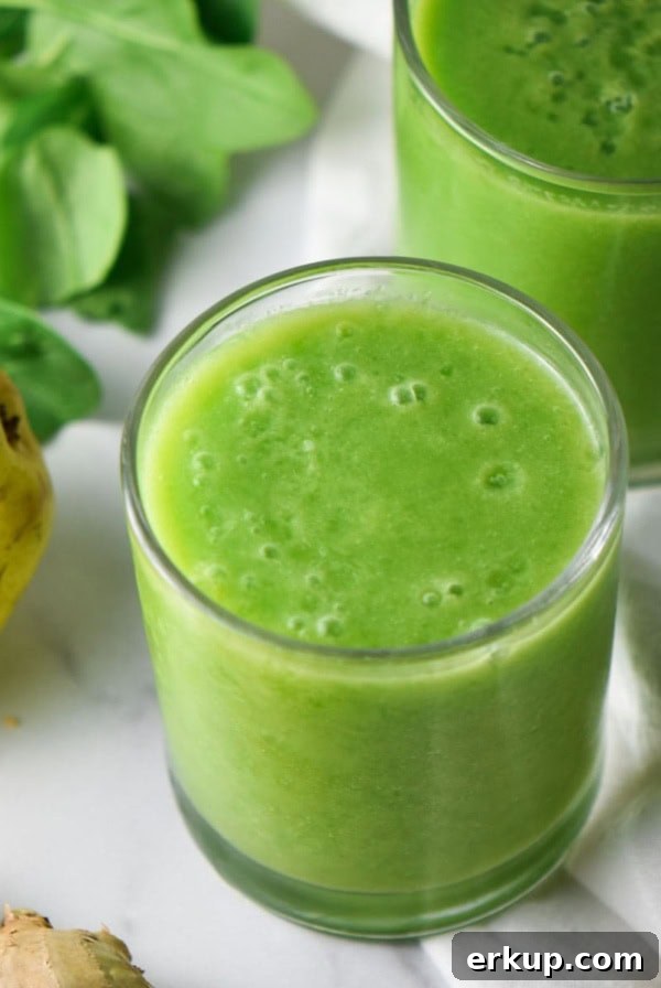 Creamy Sunflower Seed Butter and Maca Smoothie Recipe 9 A cup with an anti inflammatory green smoothie next to a pear.