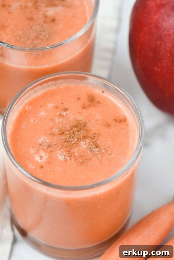 Creamy Sunflower Seed Butter and Maca Smoothie Recipe 10 Two apple carrot smoothies next to an apple and peeled carrots on a table