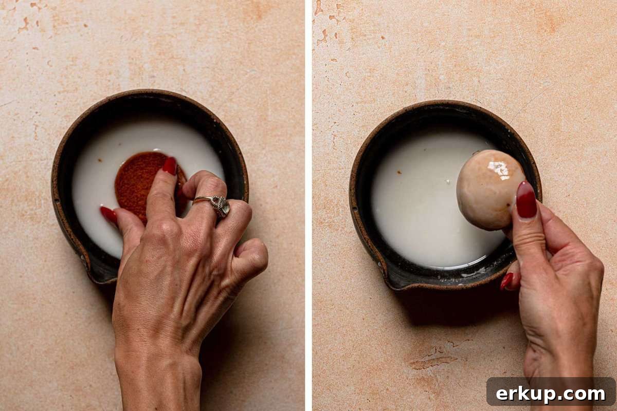 Dipping cookies in glaze.