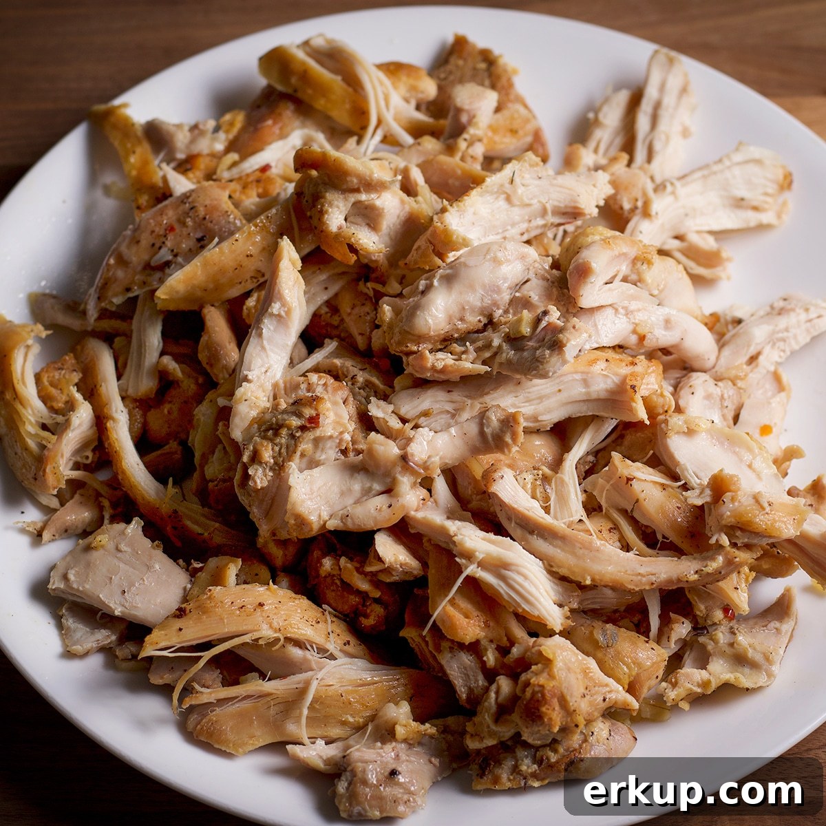 Shredded cooked chicken on a plate.