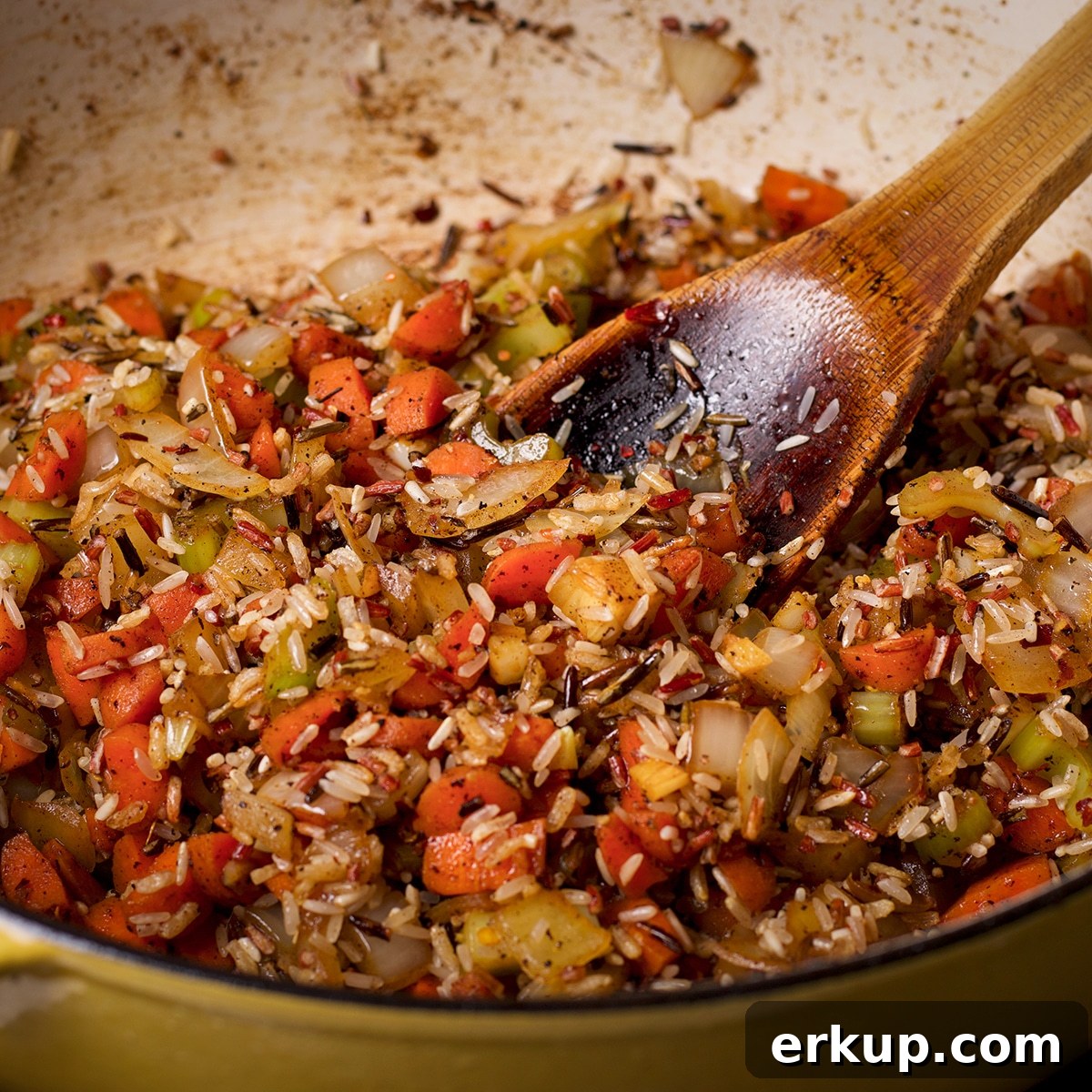Add the wild rice to the pan with the cooking vegetables.