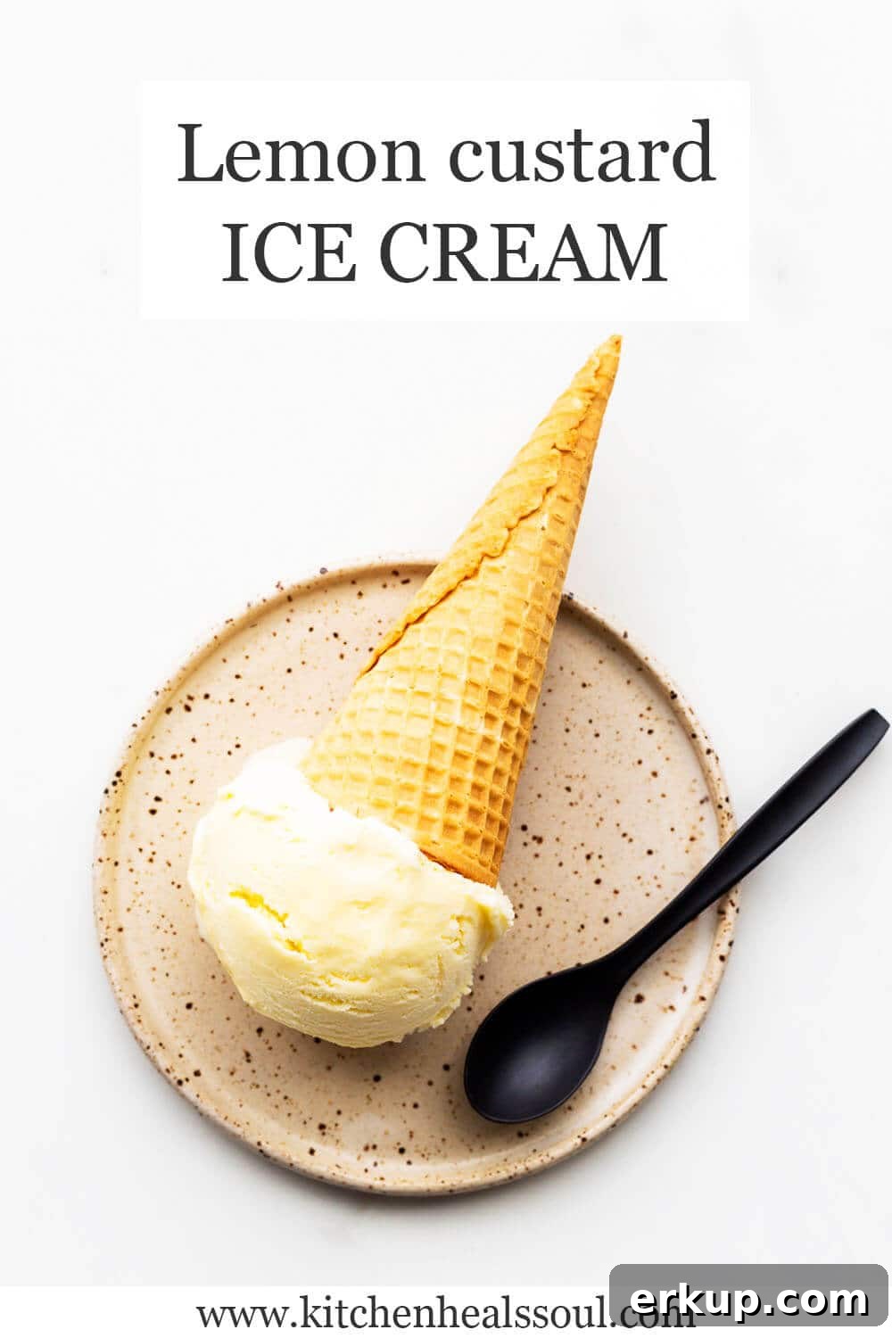 Lemon custard ice cream in a cone served on a ceramic plate with a black spoon