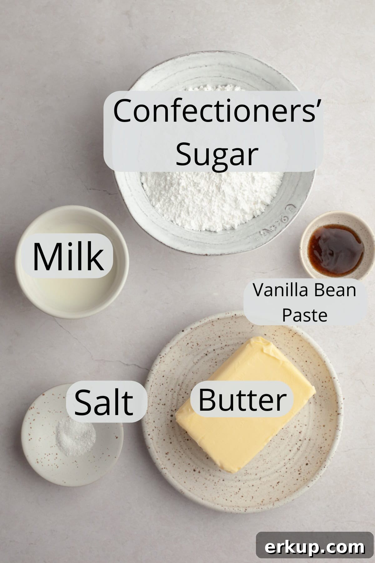 All the ingredients needed to make vanilla bean frosting, weighed out into small bowls.