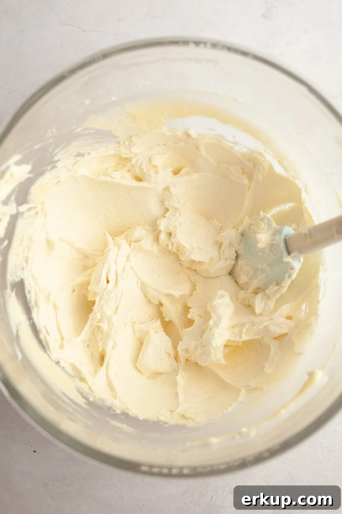 Vanilla bean frosting in a large glass bowl.