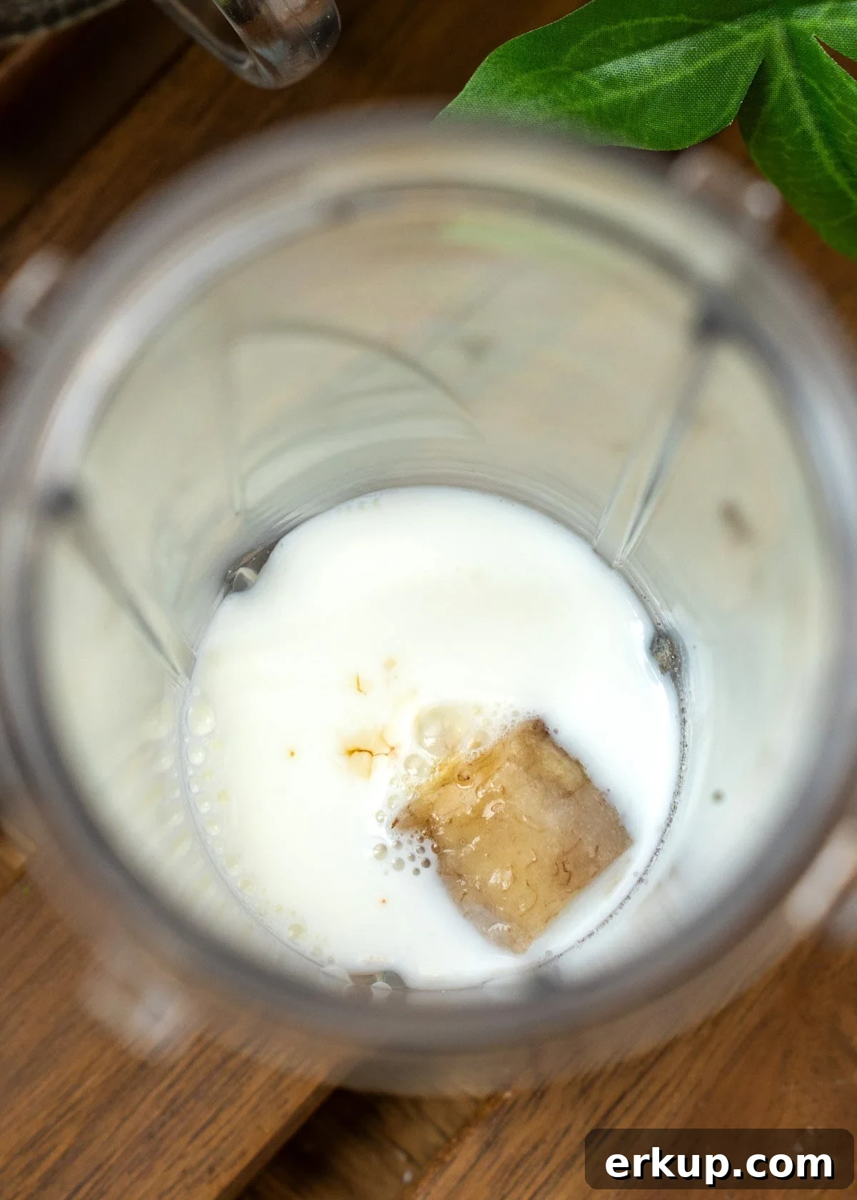 banana, milk, sugar, and vanilla extract combined in a blender