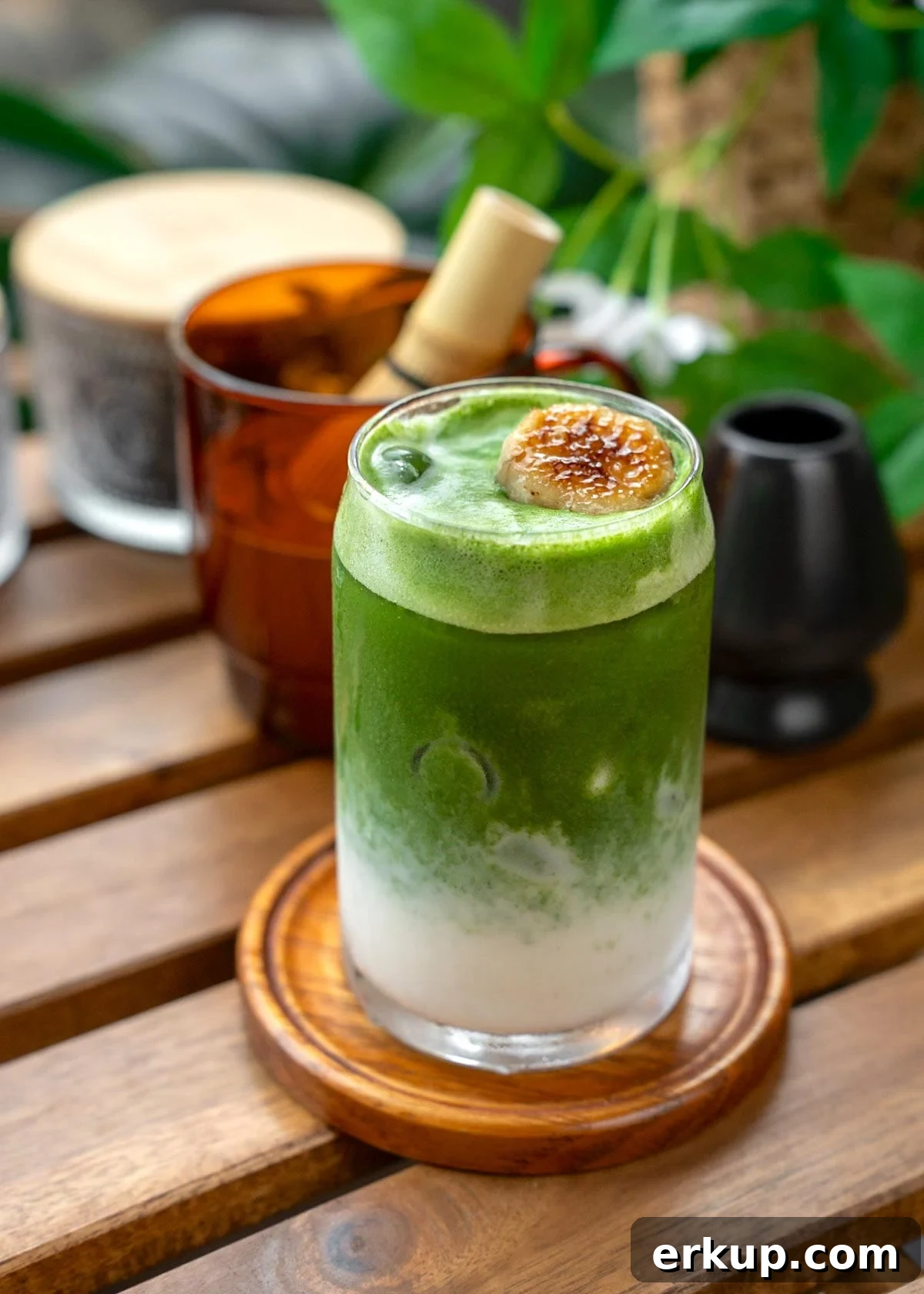 matcha layered over blended banana milk with a banana garnish