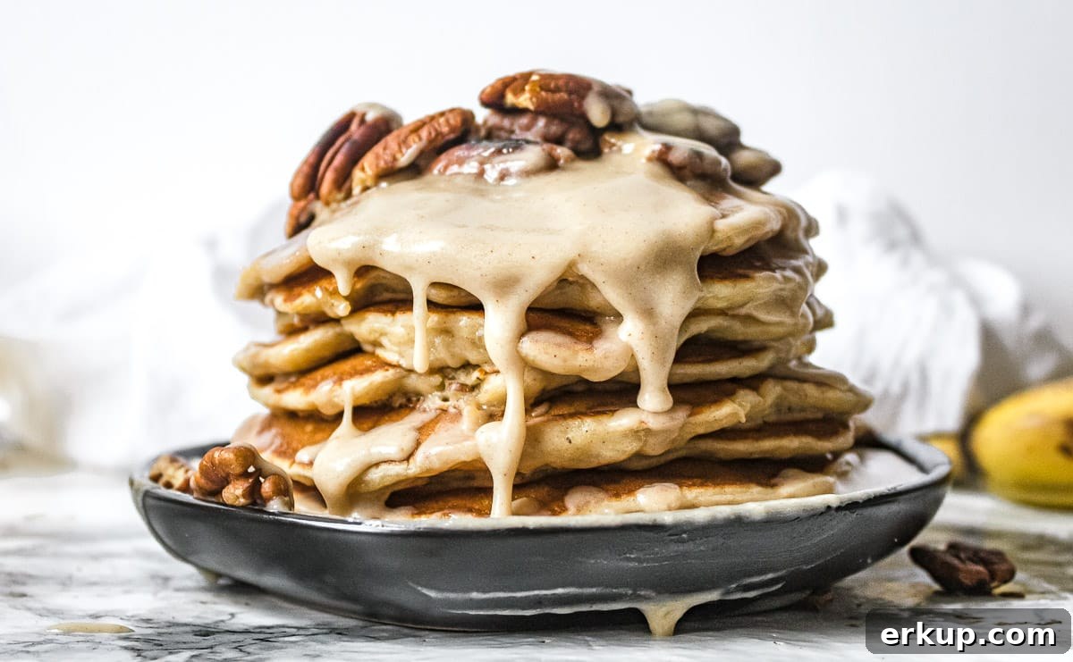 brown butter glaze and pecans on a stack of banana pancakes