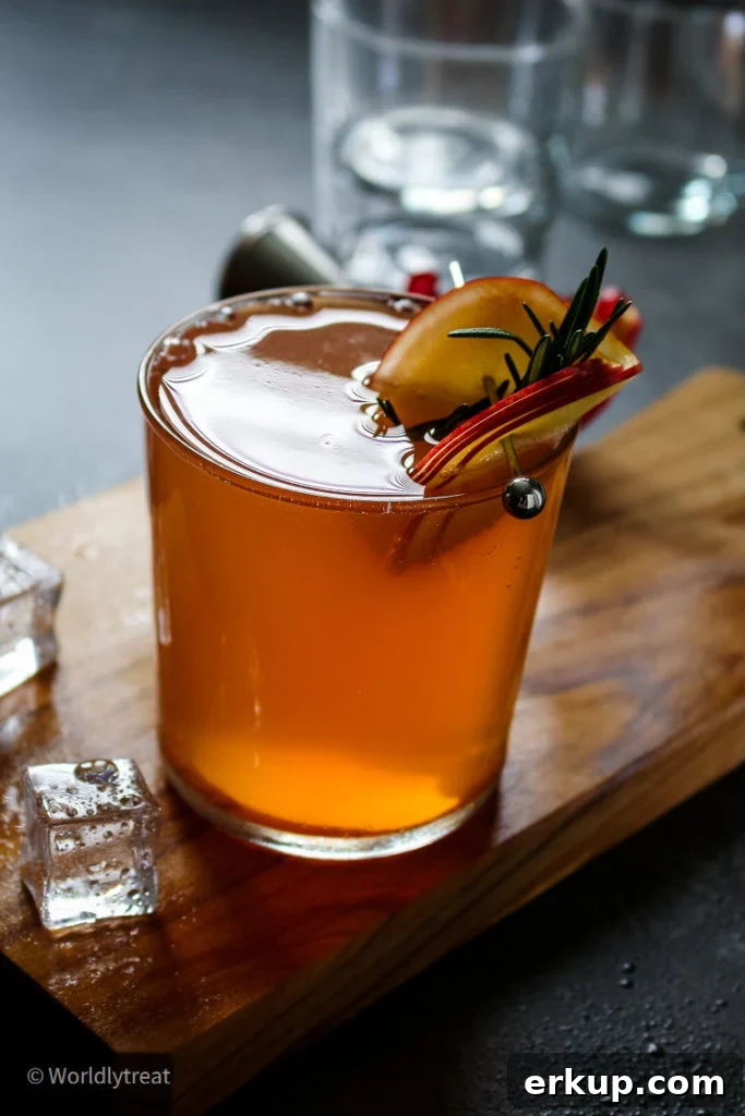 pomegranate cocktail garnished with finely sliced apples