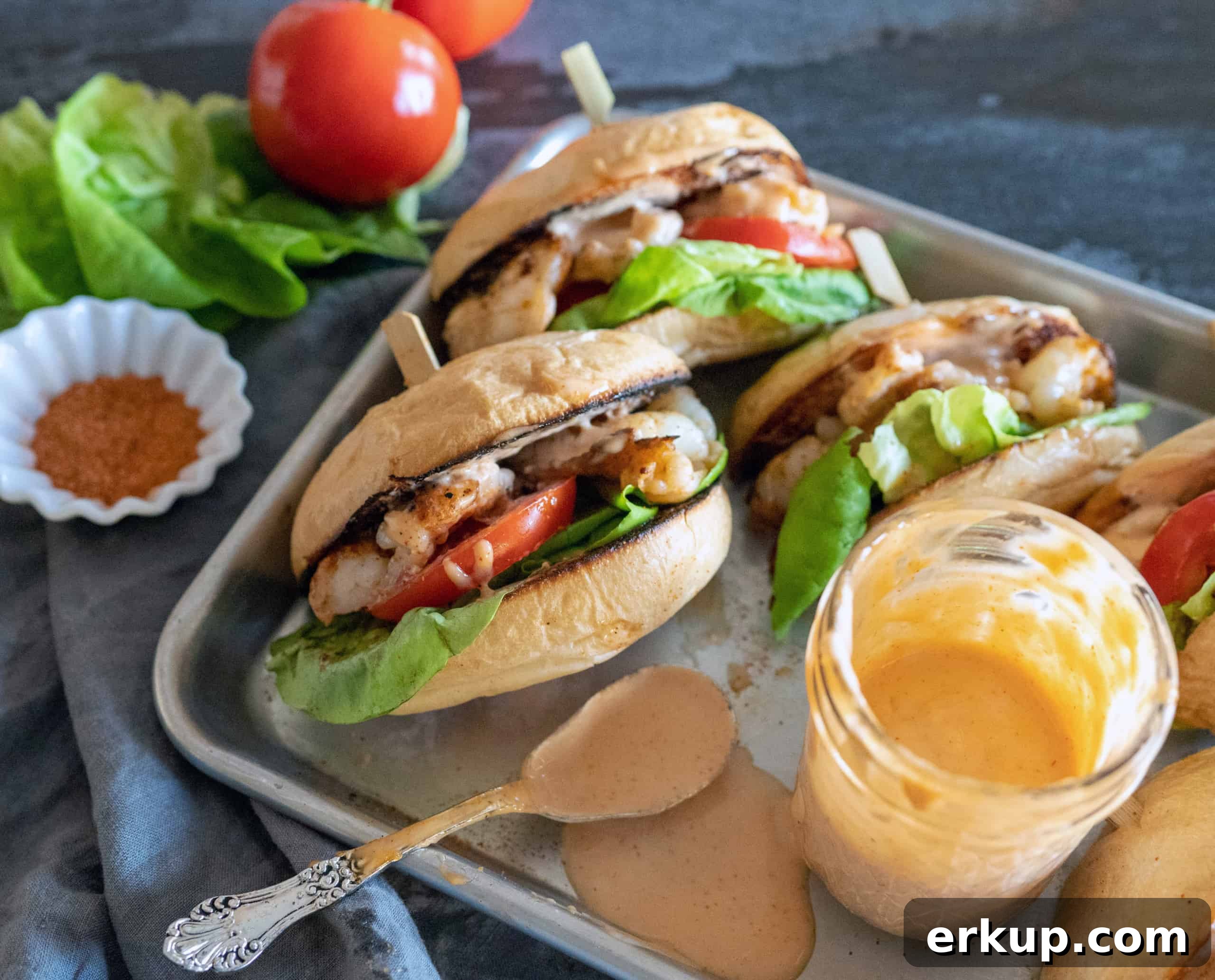 platter of smashed shrimp burgers with side of sauce