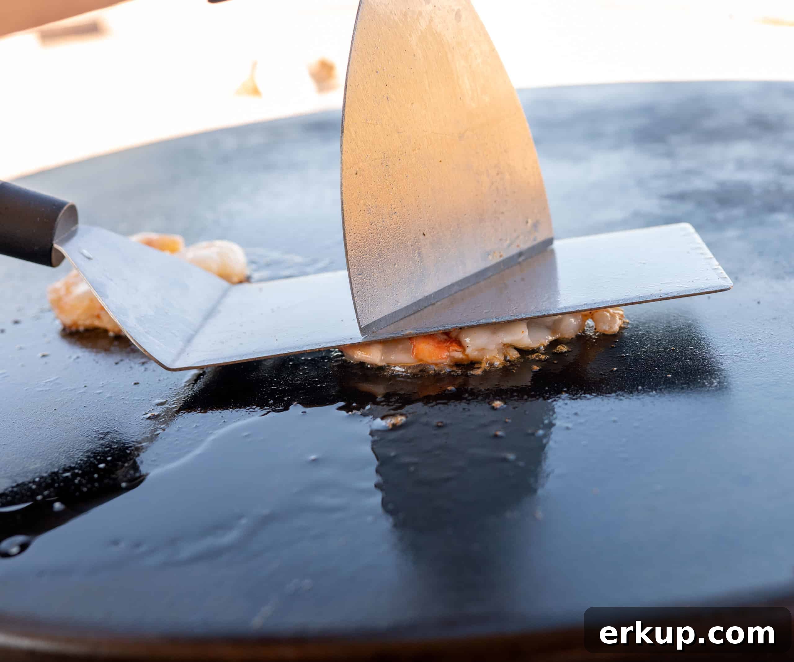 pressing shrimp down with spatula
