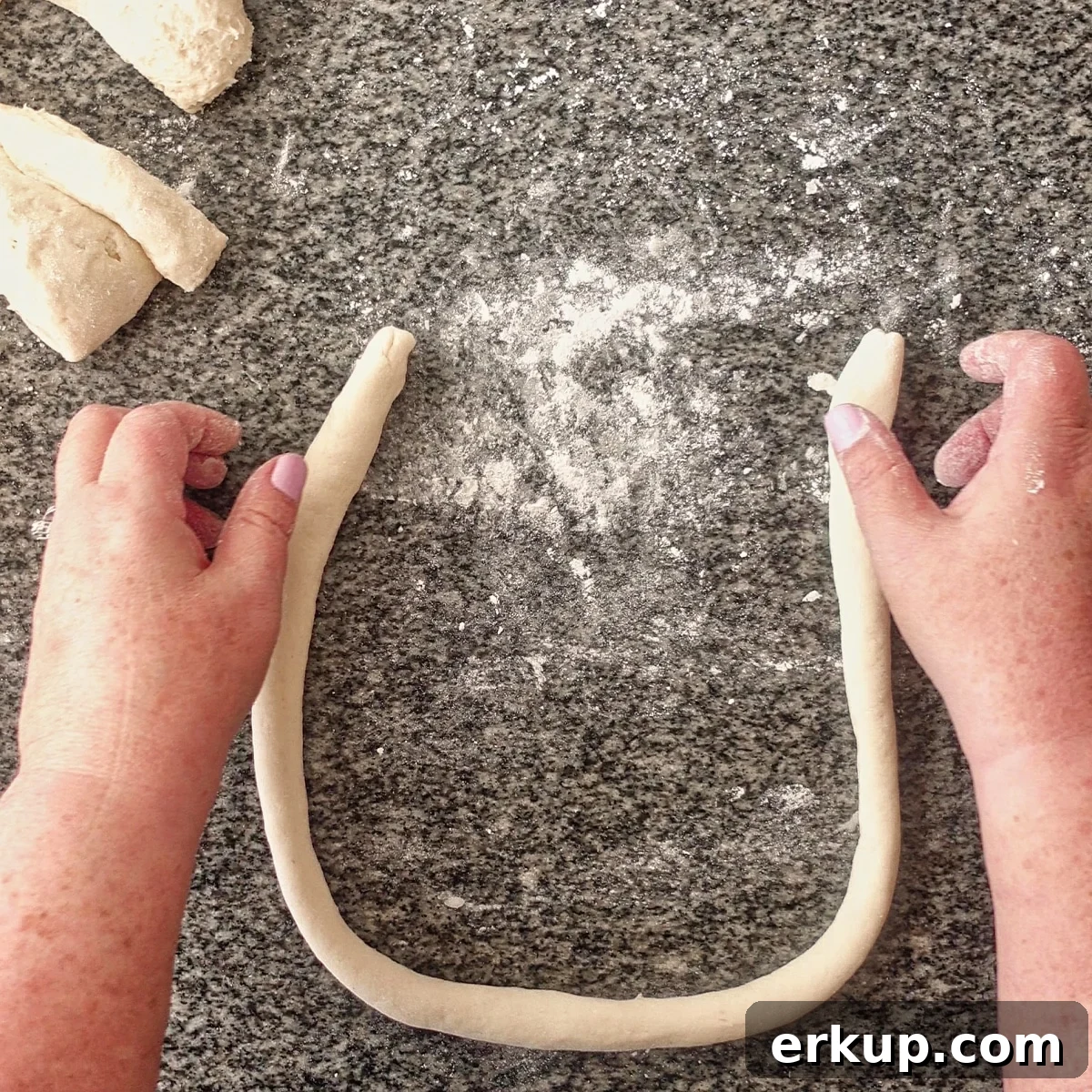 making a U shape with pretzel dough.