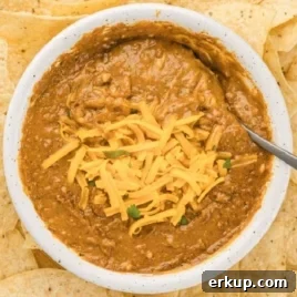 Creamy Christmas Sugar Cookie Dip Recipe for Holiday Parties 7 Overhead shot of chili cheese dip topped with shredded cheddar surrounded by tortilla chips